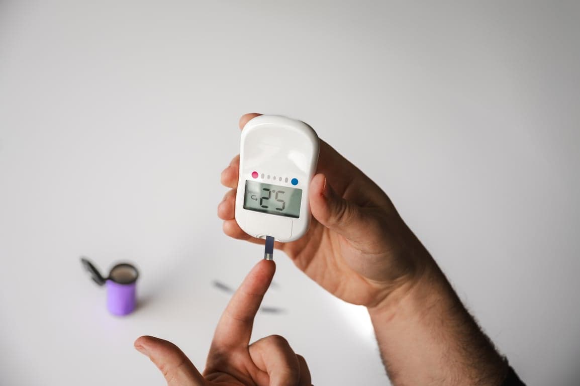 hand holding glucose meter for health monitoring